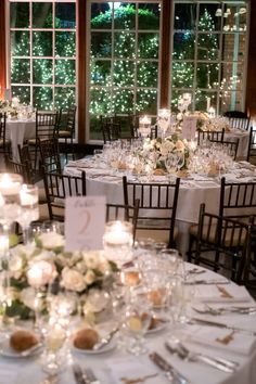 the tables are set up with candles and centerpieces for an elegant wedding reception