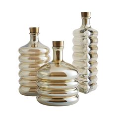 three glass vases sitting next to each other