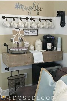 a coffee bar with cups and mugs hanging on the wall next to an open shelf