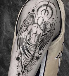 a man's arm with an angel tattoo on it