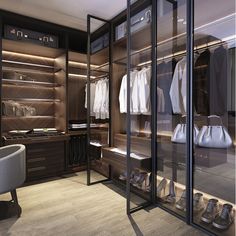 a walk in closet filled with lots of clothes and shoes next to a white chair