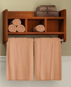 two towels are hanging on a shelf above the towel rack