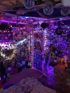 a room filled with lots of purple lights and pictures on the walls, along with other decorations