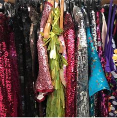 many different colored sequins are hanging on the clothes rack in front of each other