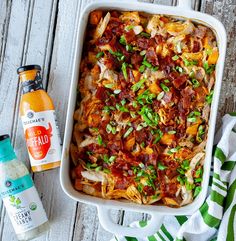 a casserole dish with bacon, green onions and seasoning next to it