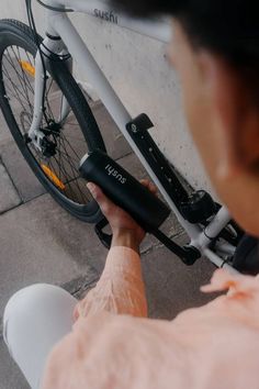 a person is fixing the handlebars on a bike