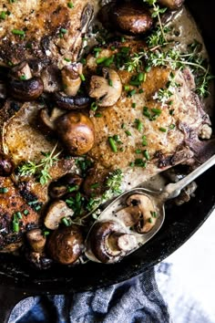 a skillet filled with meat and mushrooms