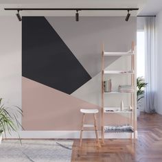 an abstract black and white wall mural in a living room with wooden flooring, bookshelves and shelves