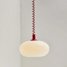 a red and white light hanging from a ceiling