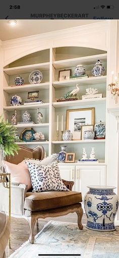 a living room filled with furniture and lots of shelves