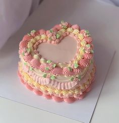 a heart shaped cake sitting on top of a table