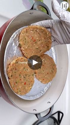 two hamburger patties being cooked in an air fryer