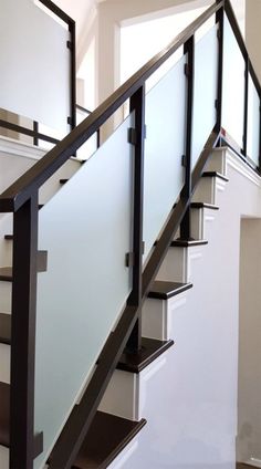 an image of a stair case with glass railings