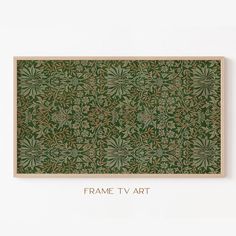 the frame tv art is made from wood and has an intricate pattern in green tones