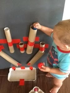 a toddler playing with construction toys on the floor