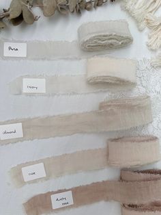 several different shades of fabric with labels on them