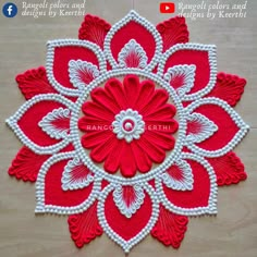 a red and white flower with beads on it