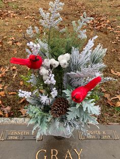 a vase filled with flowers sitting on top of a grave