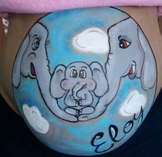 a pregnant belly with an elephant painted on it's side and the words eos written in black