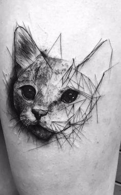 a black and white photo of a cat's face on the right side of the thigh