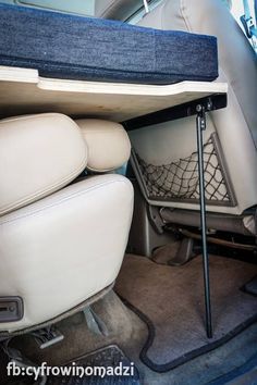 the back seat of a car with a table on it's center console area