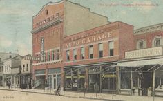 an old postcard shows the corner of a street in front of several buildings and shops