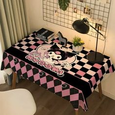 a table with a black and pink checkerboard design on it, next to a lamp