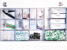 an organized drawer filled with lots of different types of toothpaste and other items