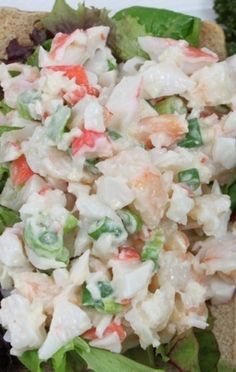 a close up view of a salad with shrimp and broccoli in it's dressing