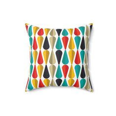 a colorful pillow with an abstract design on the front and back, in multicolored shapes