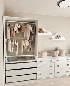 a baby's closet with clothes and toys hanging on the wall