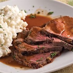 a plate with meat, mashed potatoes and gravy