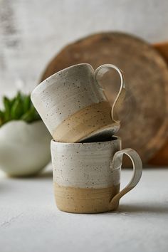 two coffee cups stacked on top of each other