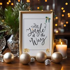 a table topped with candles and ornaments next to a sign that says, jingle all the way