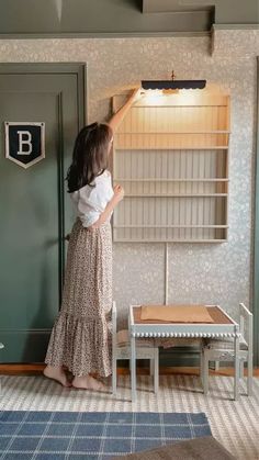 a woman standing in front of a book shelf