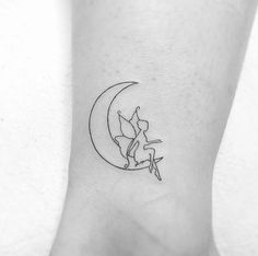 a small cat sitting on the moon tattoo