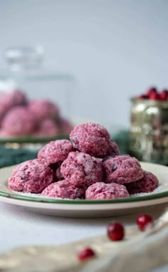 a white plate topped with cranberry cookies next to a jar of cranberries