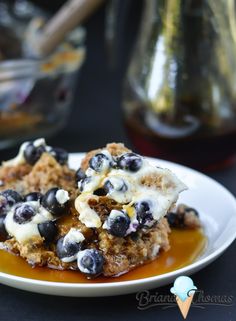 blueberries and cream covered dessert on a white plate