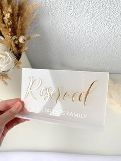 a person holding up a card that says rosed for brides family