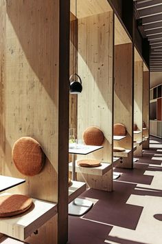 a row of tables and chairs in a room with wood paneling on the walls