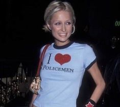 a woman wearing a t - shirt that says i love policemen with a heart on it