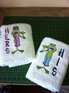 two towels with embroidered images of people on them sitting on a cutting board next to each other