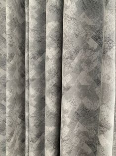 the curtain is made up with grey and white patterns