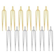 six pairs of gold and silver metal needles with spikes on each end, set against a white background