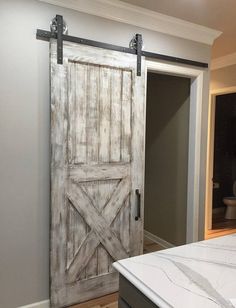 a bedroom with a bed and sliding barn door