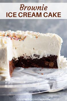 a chocolate ice cream cake with white frosting and sprinkles on top