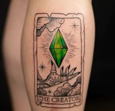 a green diamond tattoo on the leg with clouds and mountains in the background that reads, the creator