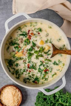 broccoli and cheese soup in a pot with a wooden spoon next to it