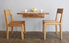 two small wooden tables with bowls on them