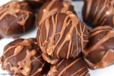 chocolate covered candies are piled on top of each other with drizzled chocolate